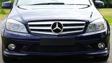 Blue mercedes Sedan Near Green Grass Field during Day Time