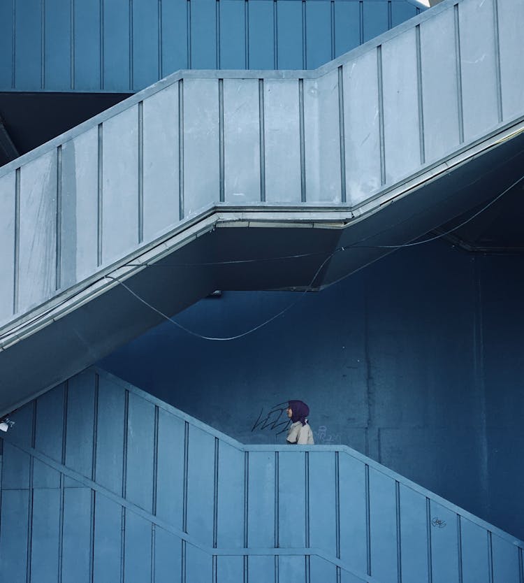 Woman In Purple Hijab Walking On Stairs