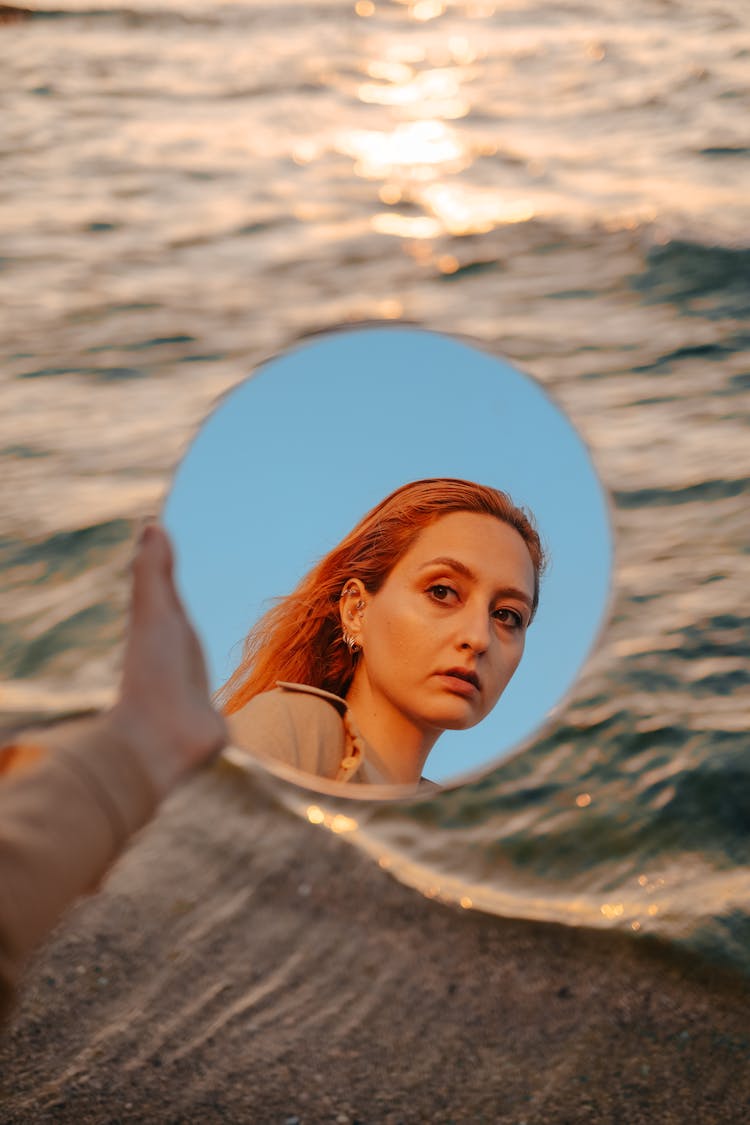 Woman Reflection In Mirror Over Water