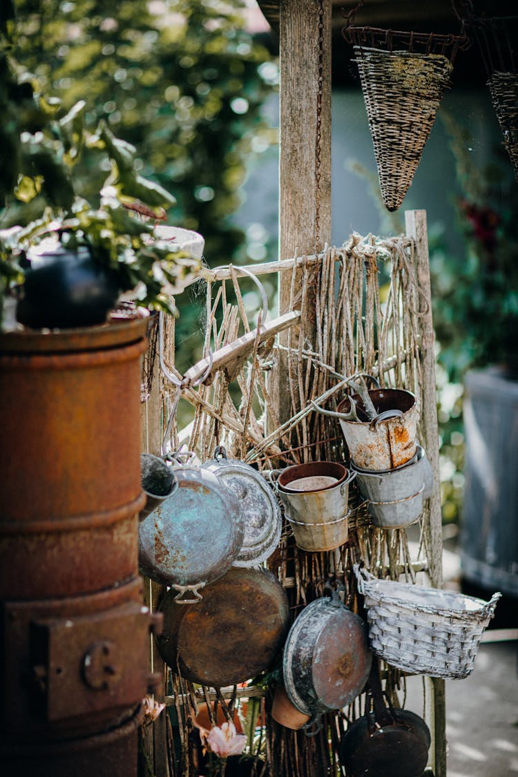 Pots And Pans Hanging By Rusty Stove 