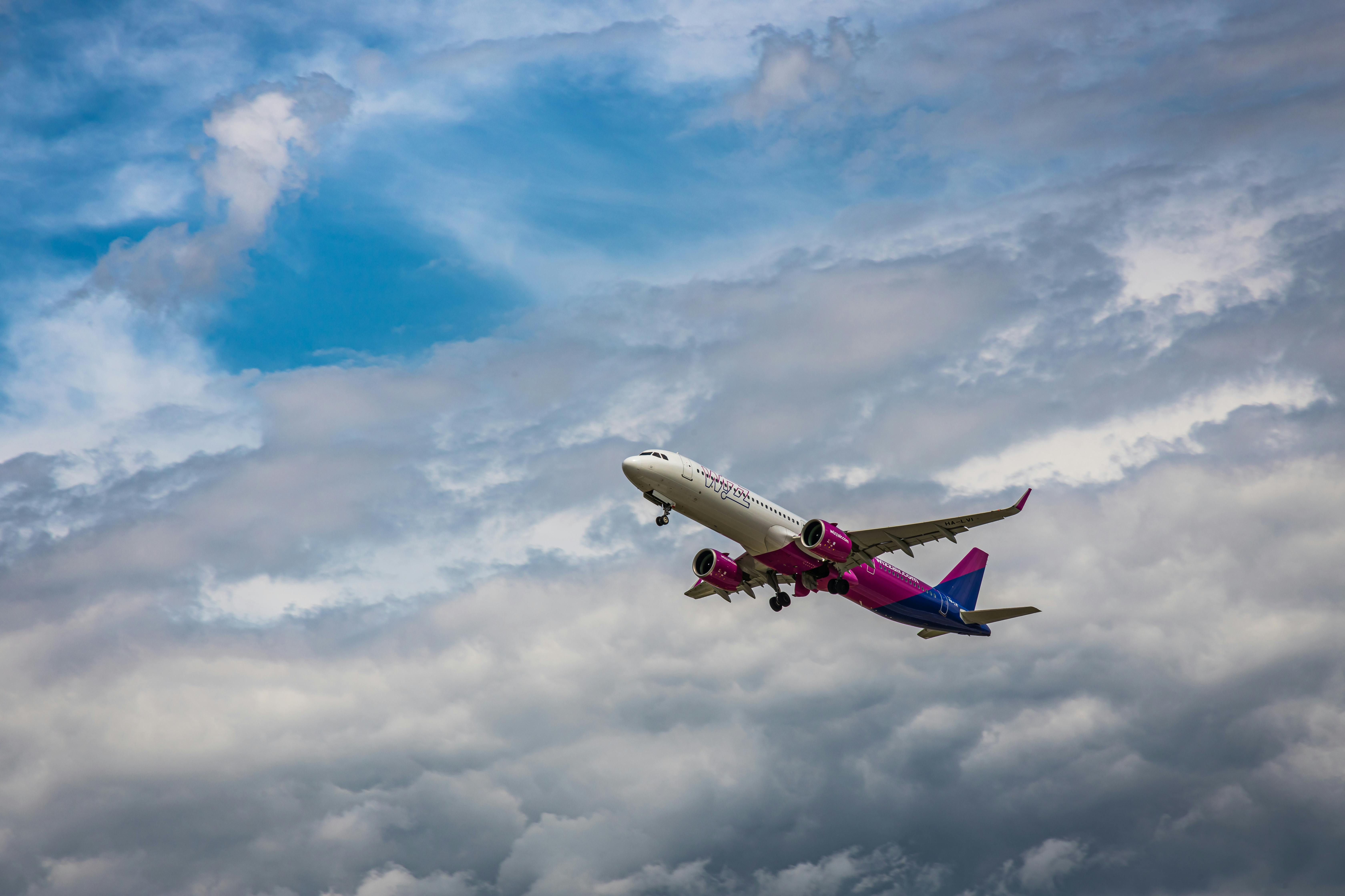 Low Angle Photo of Airplane Flying Under Sky · Free Stock Photo