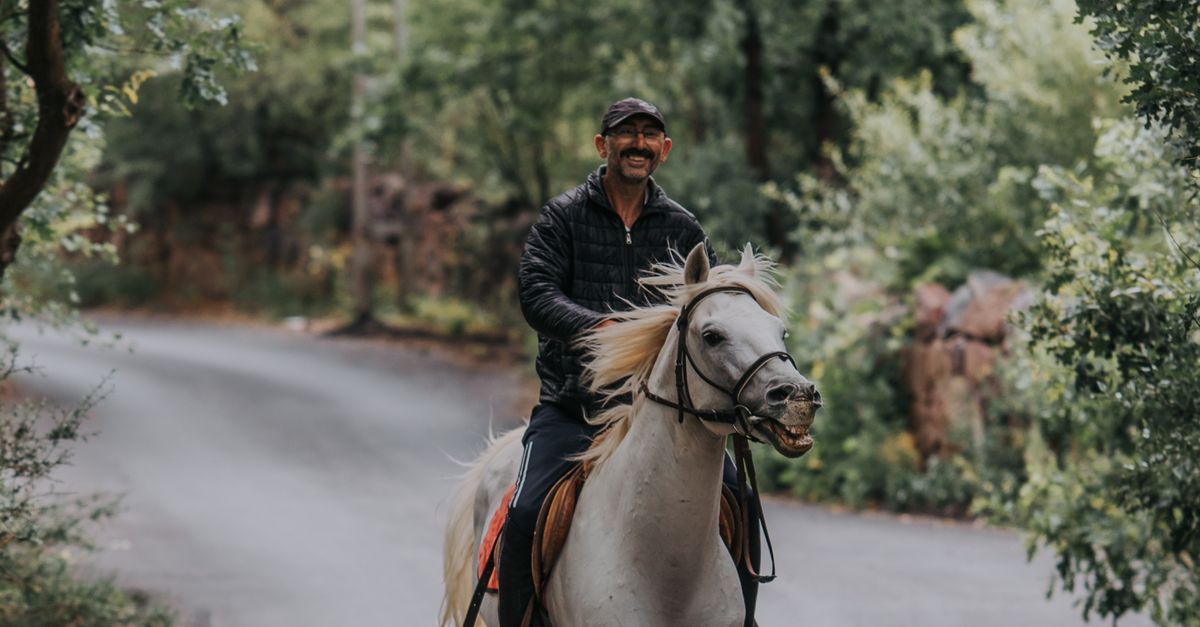 Man Riding Horse on Road · Free Stock Photo