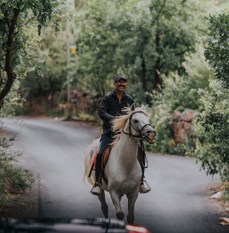 Man Riding Horse On Road