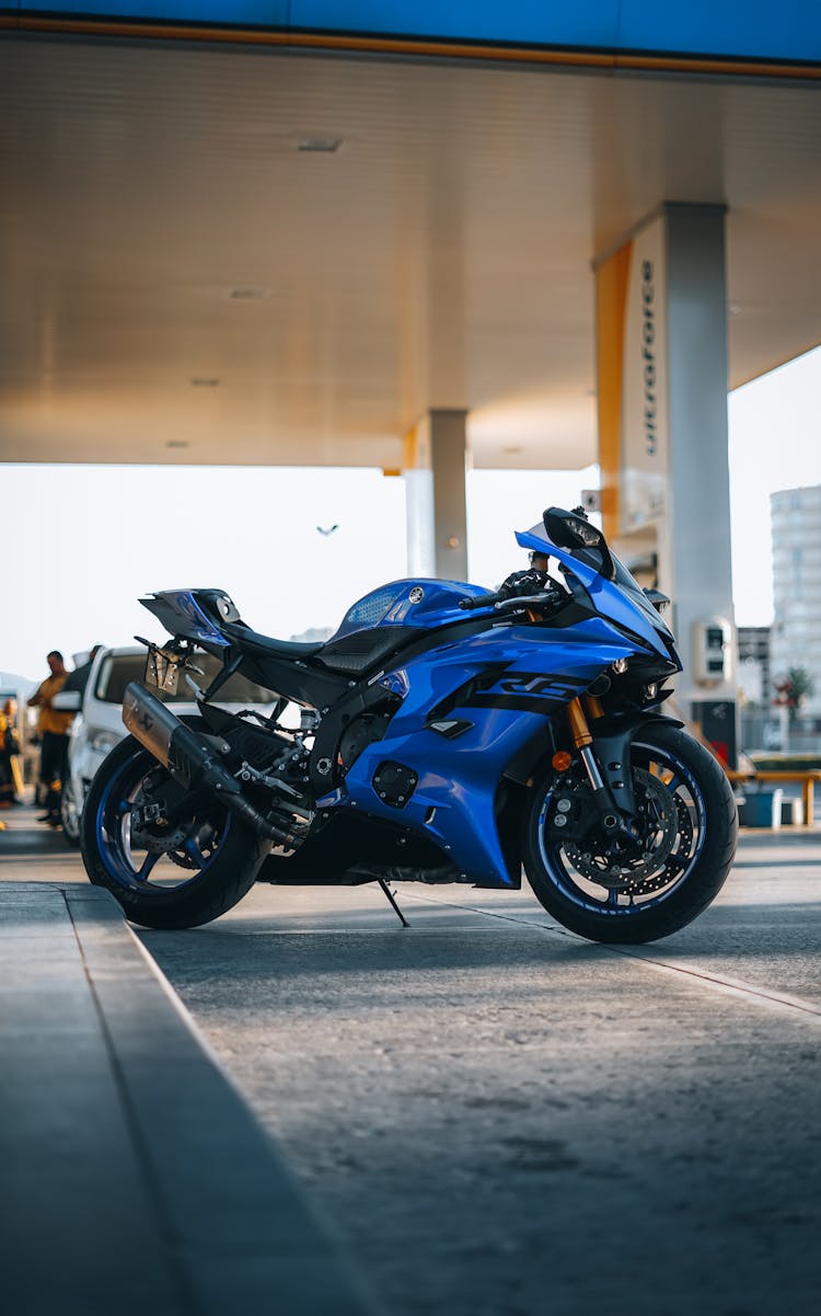 Blue Motorcycle Parked On Concrete Road