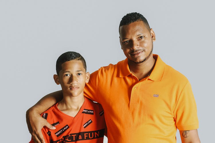 Father And Son Wearing Orange Shirts