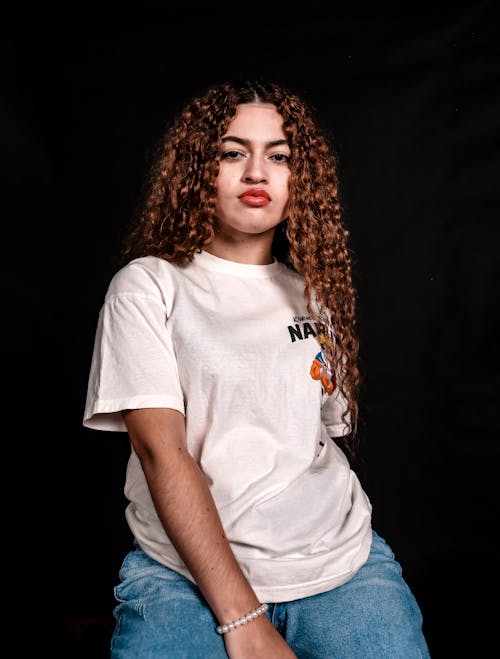 Serious Woman in White T-shirt and Denim Jeans 