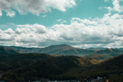 Free Breathtaking aerial view of the Smoky Mountains under a cloudy blue sky in Pigeon Forge. Stock Photo