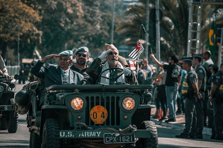 Soldiers Saluting Riding An Army Vehicle