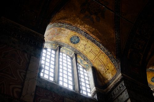 Free A beautifully ornate, low-angle shot of an Ottoman arched window inside a mosque, showcasing intricate architecture. Stock Photo