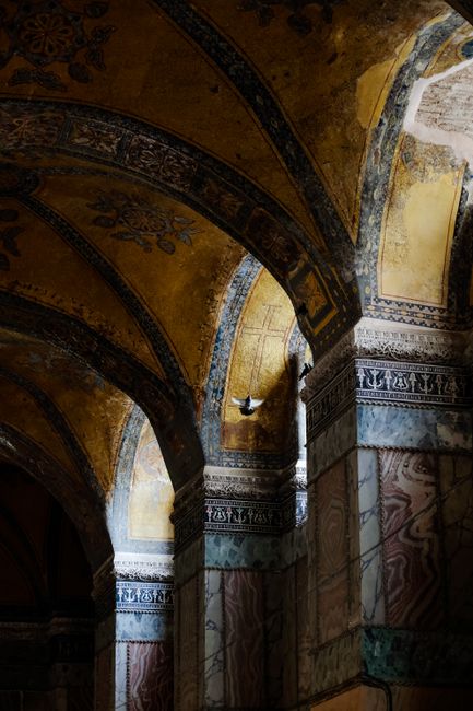A low-angle shot of ornate arches, highlighting patterns and interplay of light and shadow.