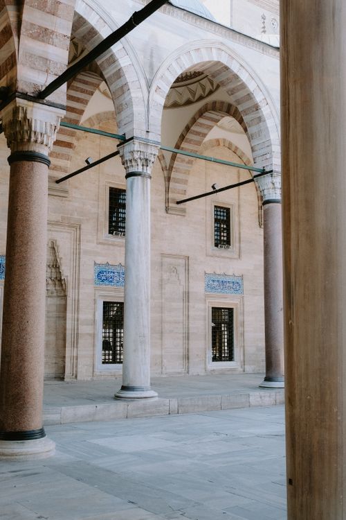 Free Elegant arched courtyard of Suleymaniye Mosque in Istanbul, showcasing Ottoman architecture. Stock Photo