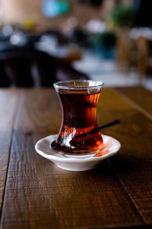 Turkish Tea in a Clear Glass on White Ceramic Saucer