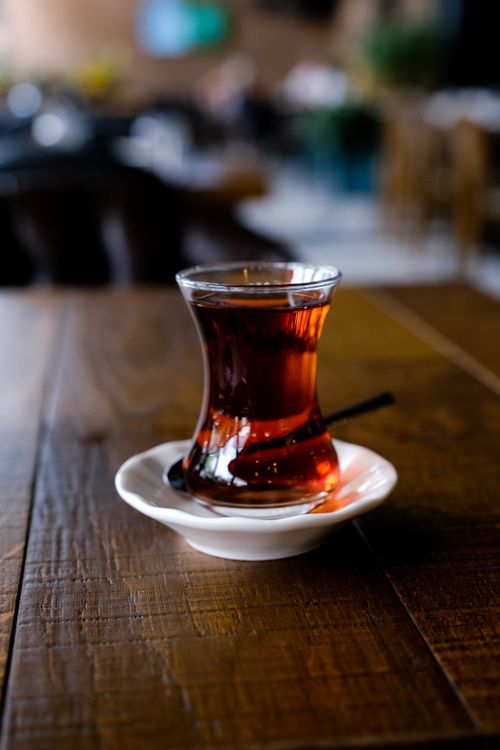 Free Close-up of Turkish tea served in a clear glass on a wooden table, creating a cozy atmosphere. Stock Photo