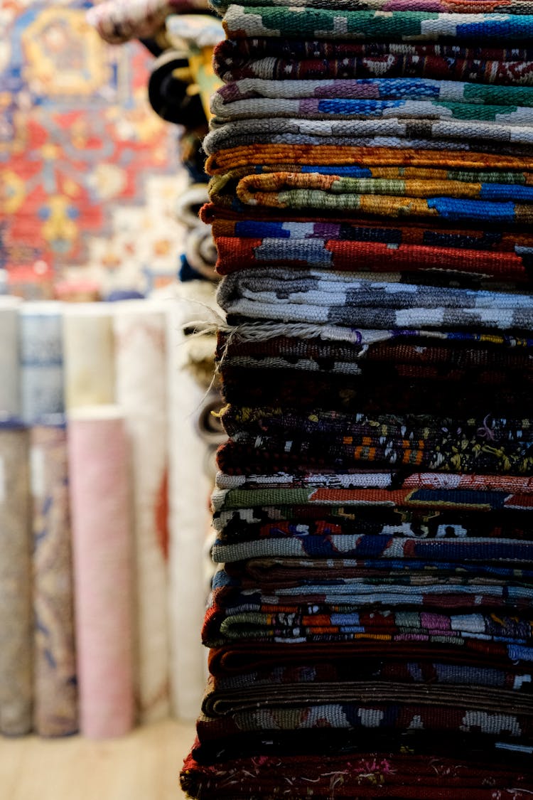 Close-up Photo Of Stacked Fabrics 