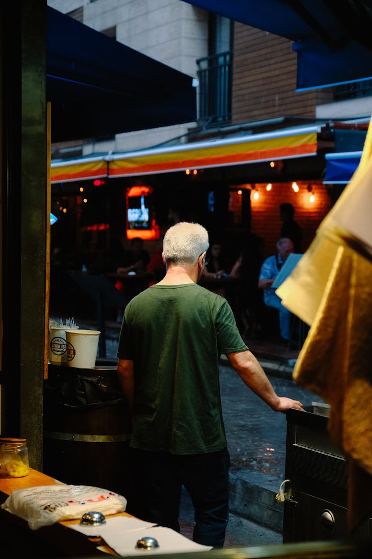 Man Between Market Booths On City Street