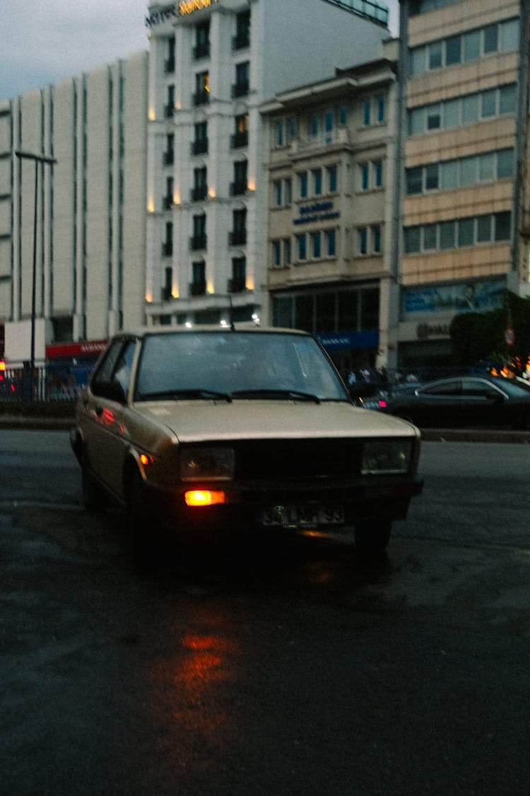 Car Turning On City Street