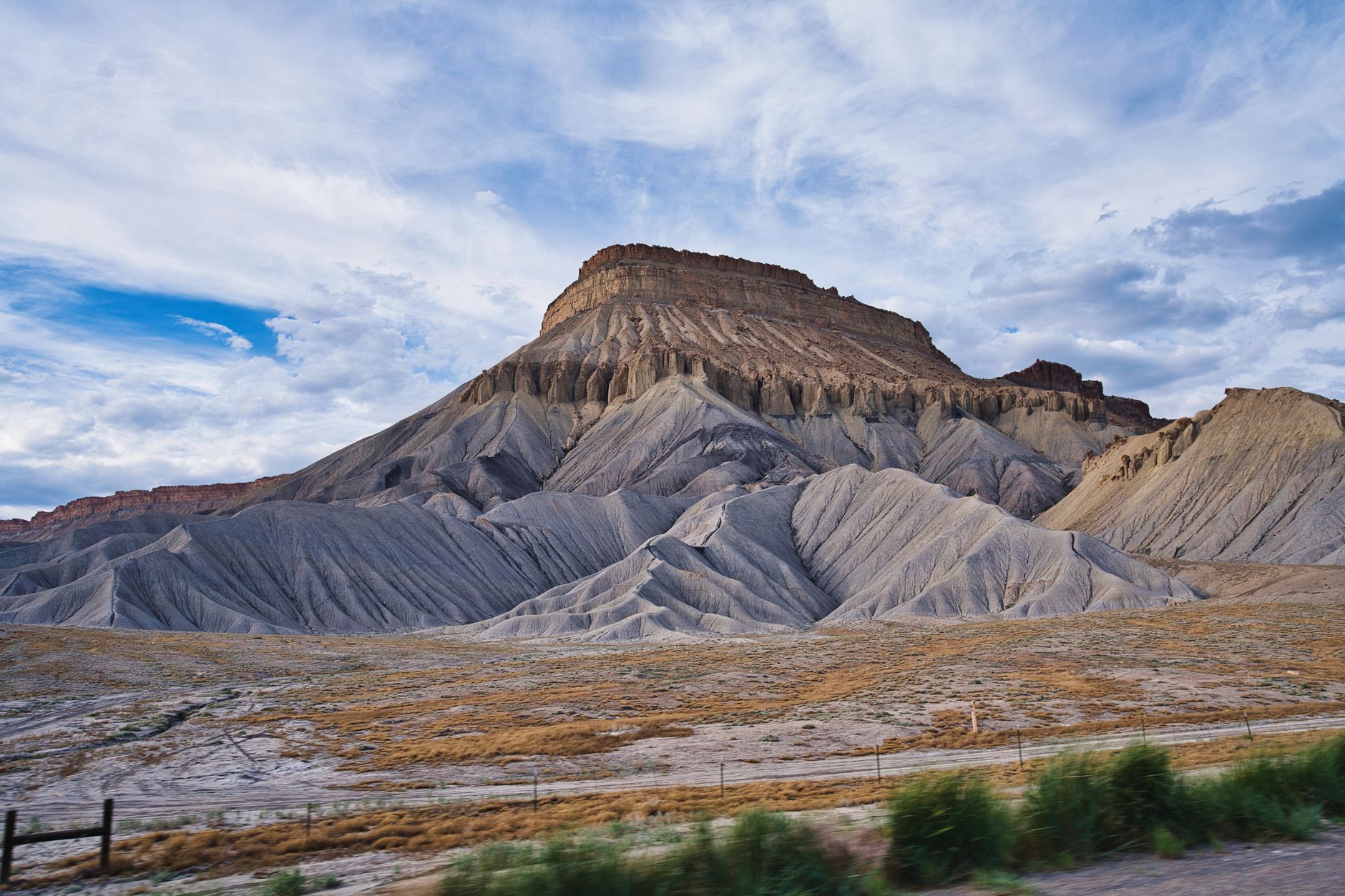 Dramatic rock formations of Mount Garfield under a bright blue sky in Grand Junction, Colorado.