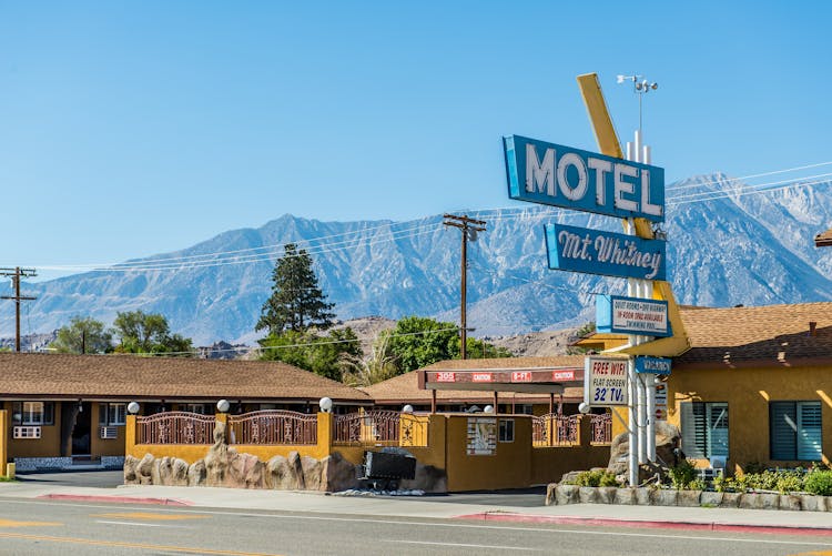 A Motel With A Mountain Background