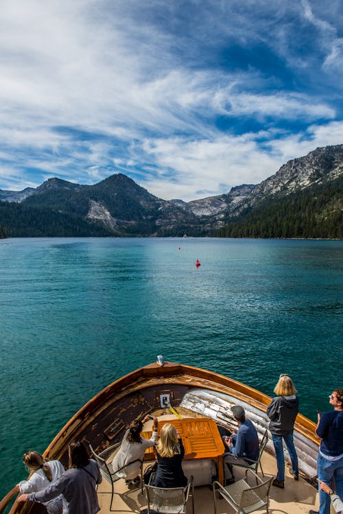 People on a Boat Sailing with the View on Sierra Nevada Mountain Range 
