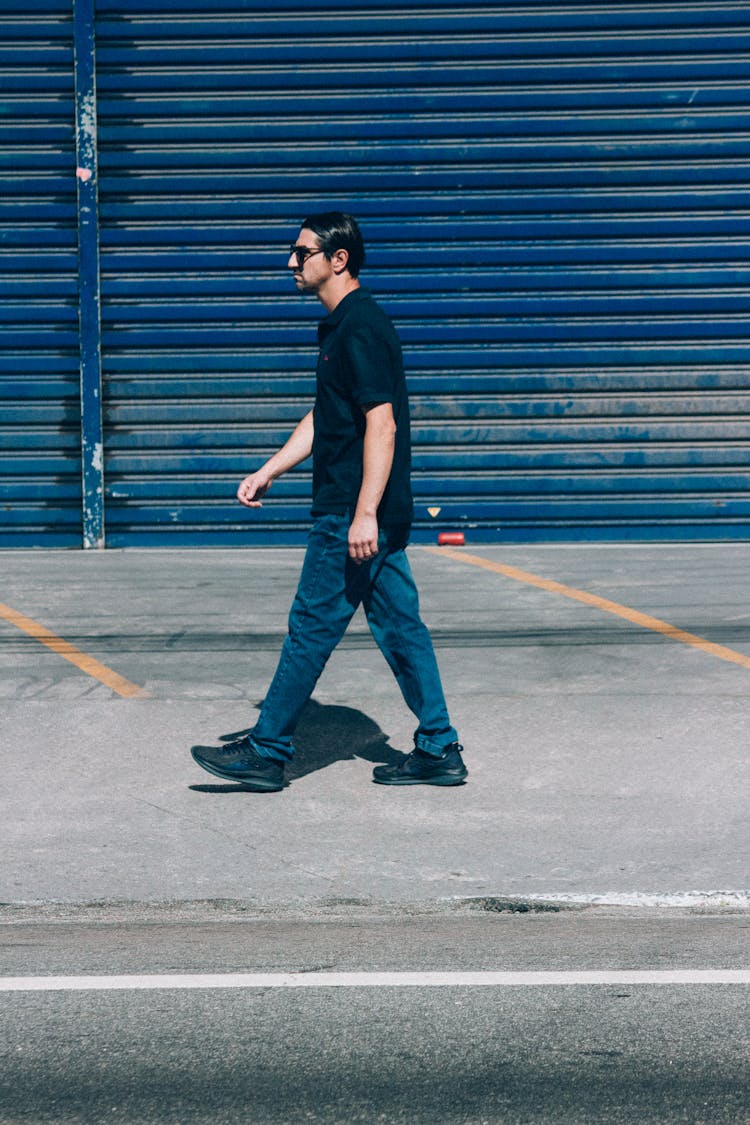 Man Walking On The Sidewalk 