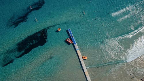 Drone Shot of Boats, a Pier and a Sea