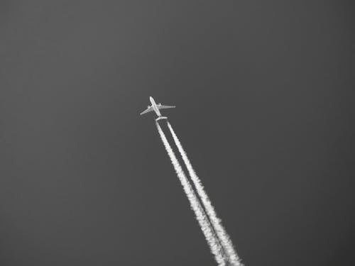 Fighter Jet Flying on Sky Grayscale Photo