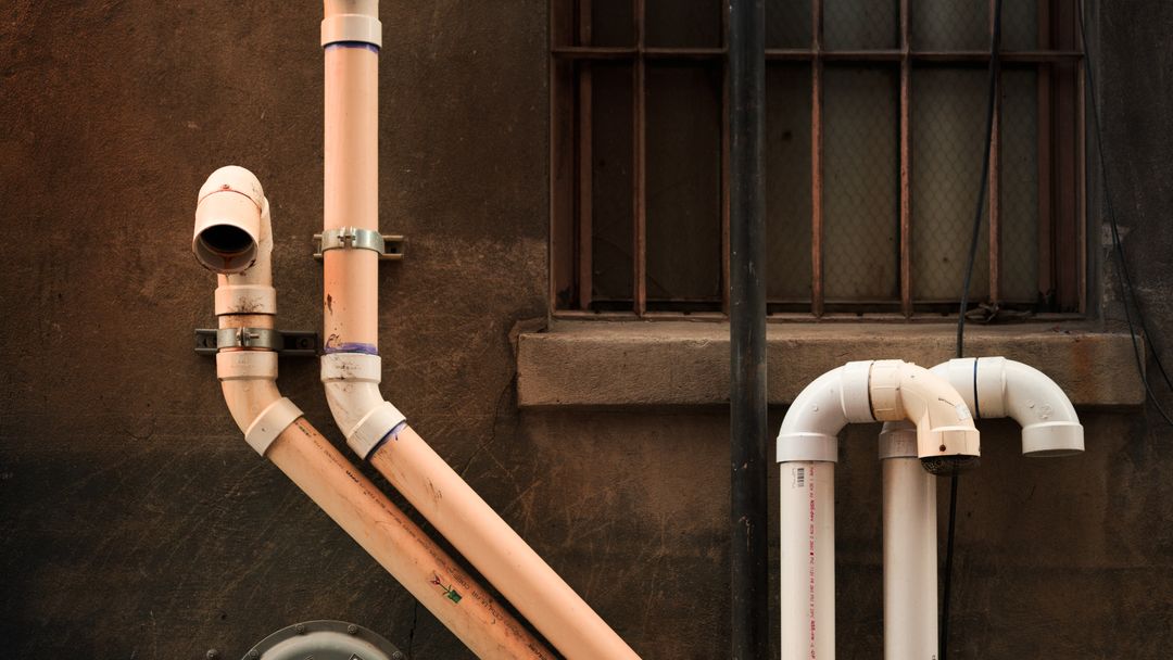 Pipework installed up the exterior wall of a building
