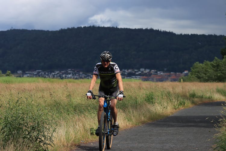 Man Riding A Bicycle Near Field