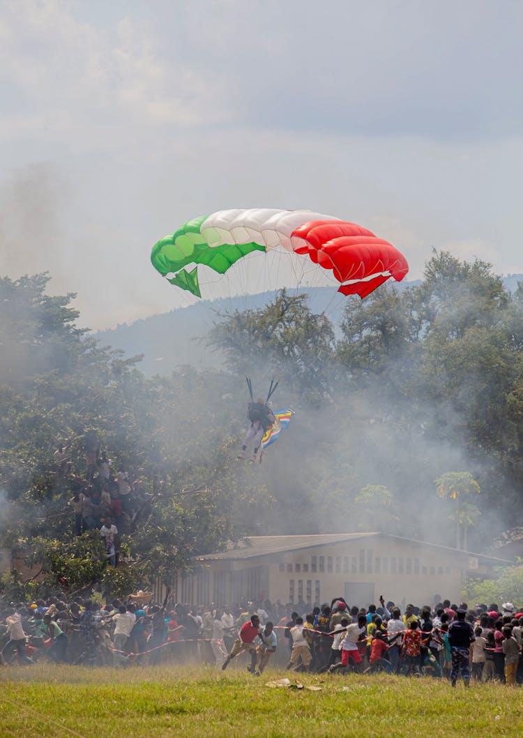 Man On Paragliding And Panicking Crowd