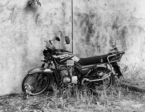 Grayscale Photo of a Damaged Motorcycle