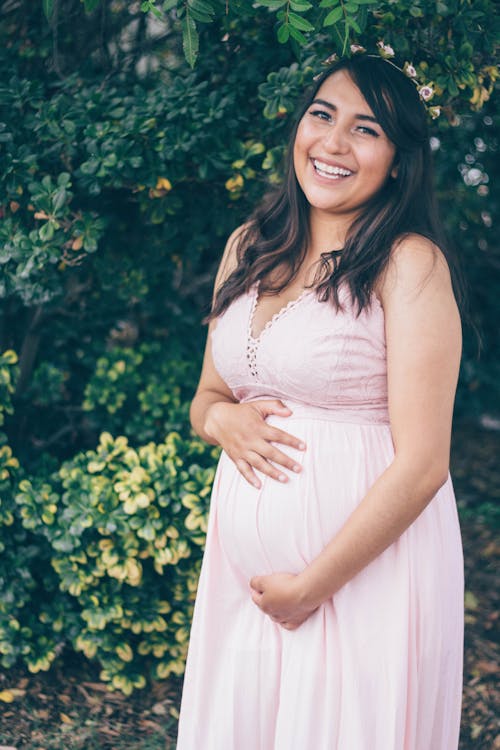 Beautiful Pregnant Woman Wearing a Pink Dress