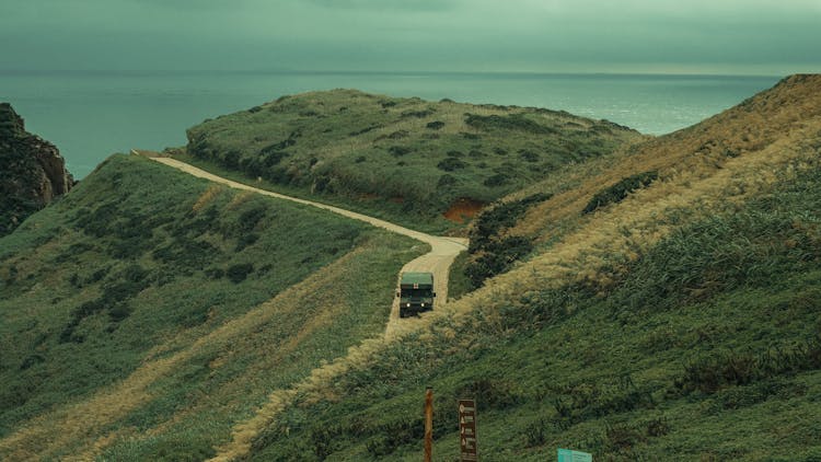 Military Truck Driving Through Hills