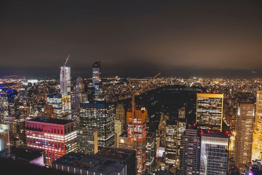 A breathtaking aerial view of New York City's illuminated skyline at night, showcasing vibrant city lights.