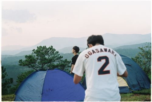 Free Two men camping with tents, enjoying scenic mountain views in the great outdoors. Stock Photo
