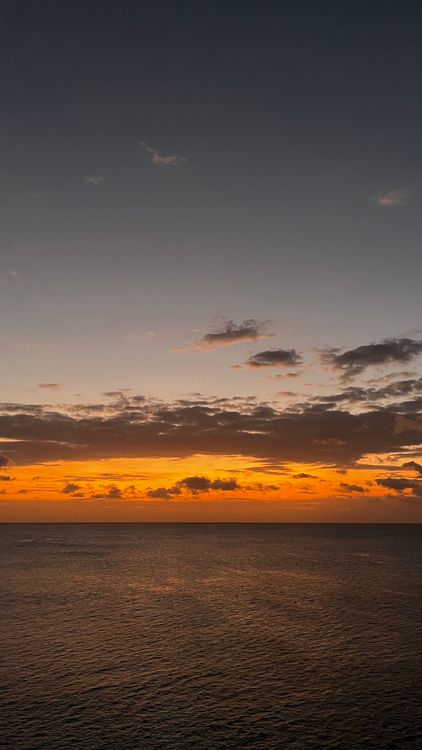 View of a Sea Under the Cloudy Sky During Golden Hour · Free Stock Photo