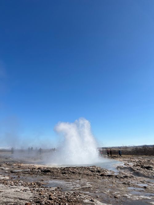 Free Dramatic eruption of Strokkur geyser in Iceland against a clear blue sky. Stock Photo