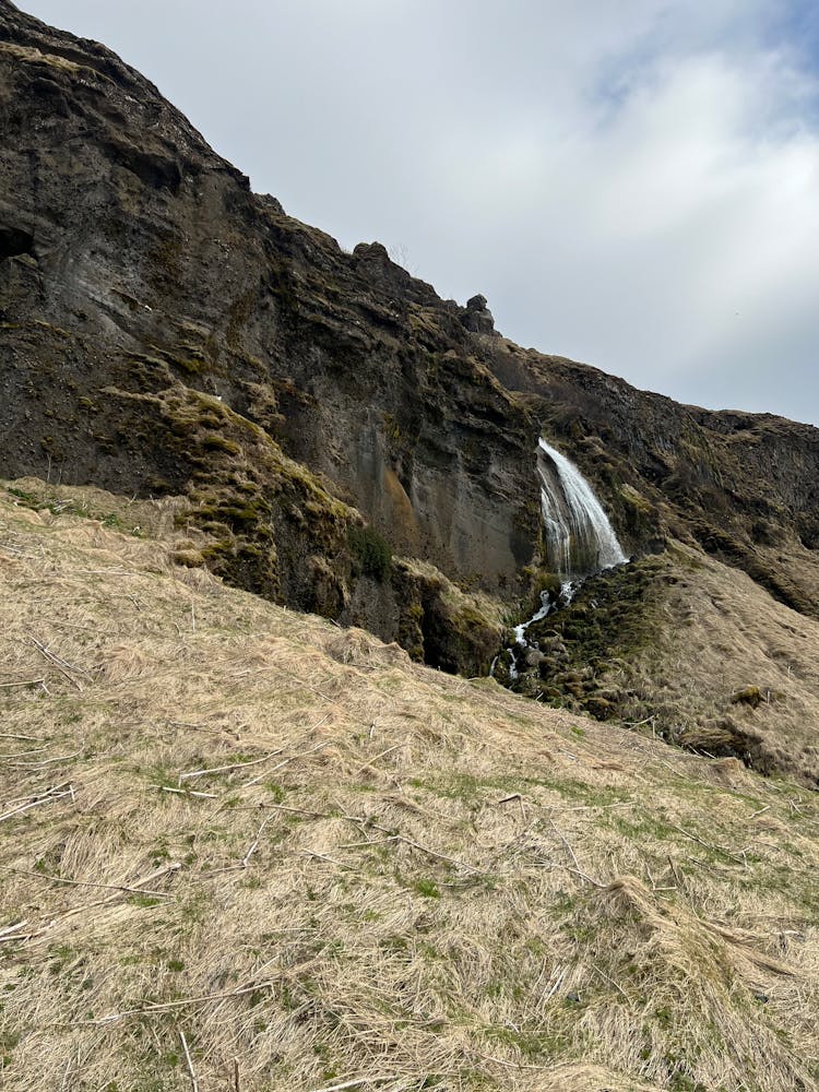 Waterfall On Rock In Wild Nature