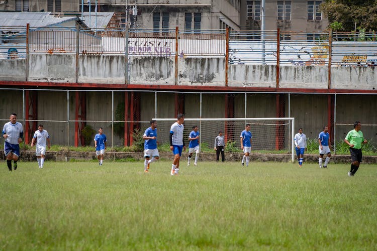 Men Playing Soccer On A Field