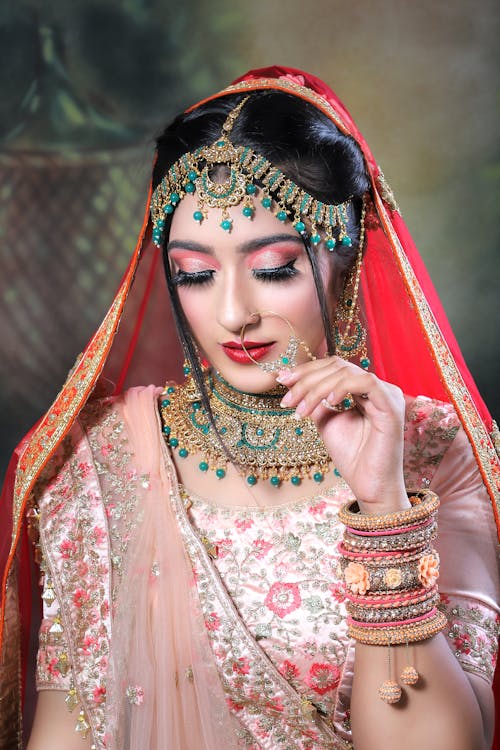 Beautiful Bride Wearing Veil and Traditional Clothing and Jewelry