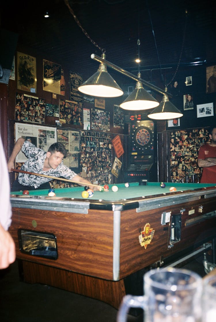 A Man Playing Billiards In A Bar