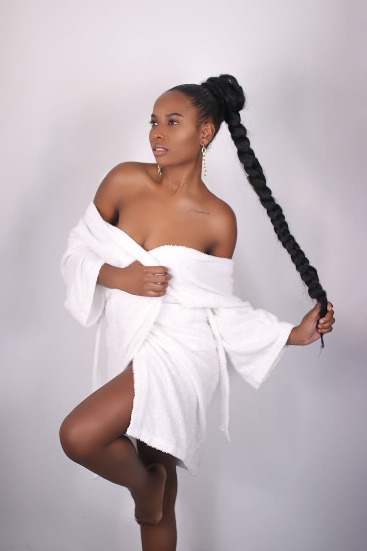 A Woman With Braided Hair Wearing A Bathrobe