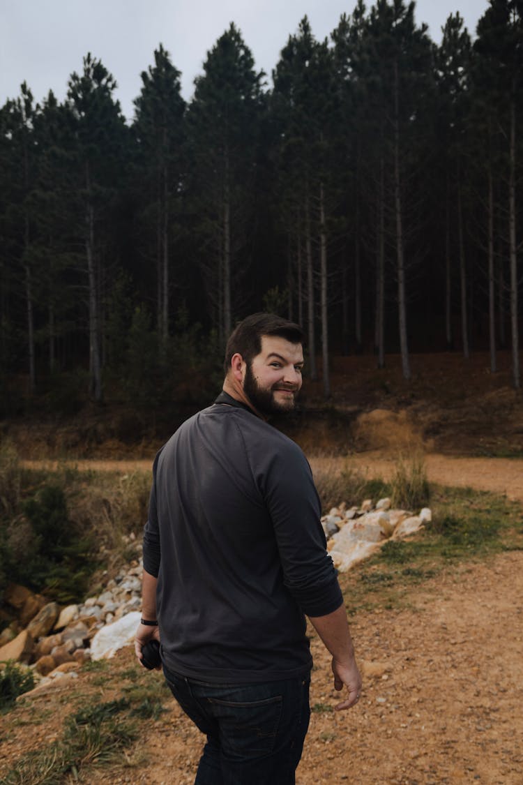 Back View Of A Bearded Man Walking To A Forest