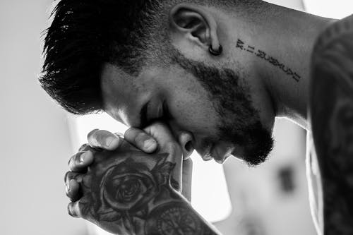 Free Man Tattooed Praying Stock Photo