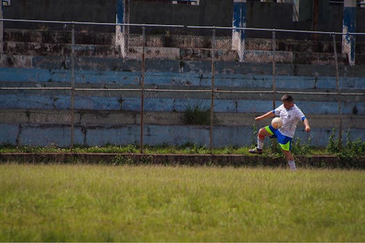 Soccer player in action on a grassy field, showcasing athletic skills outdoors.