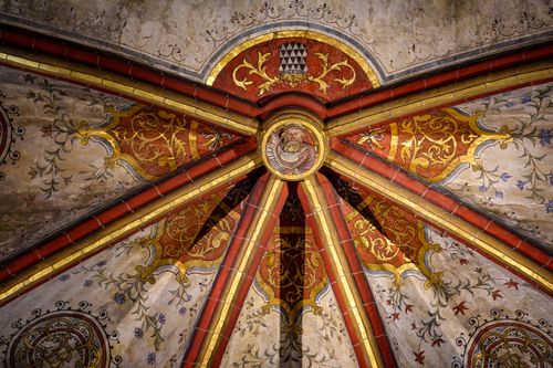 Free Close-up of a richly decorated Gothic ceiling with religious motifs in a cathedral. Stock Photo