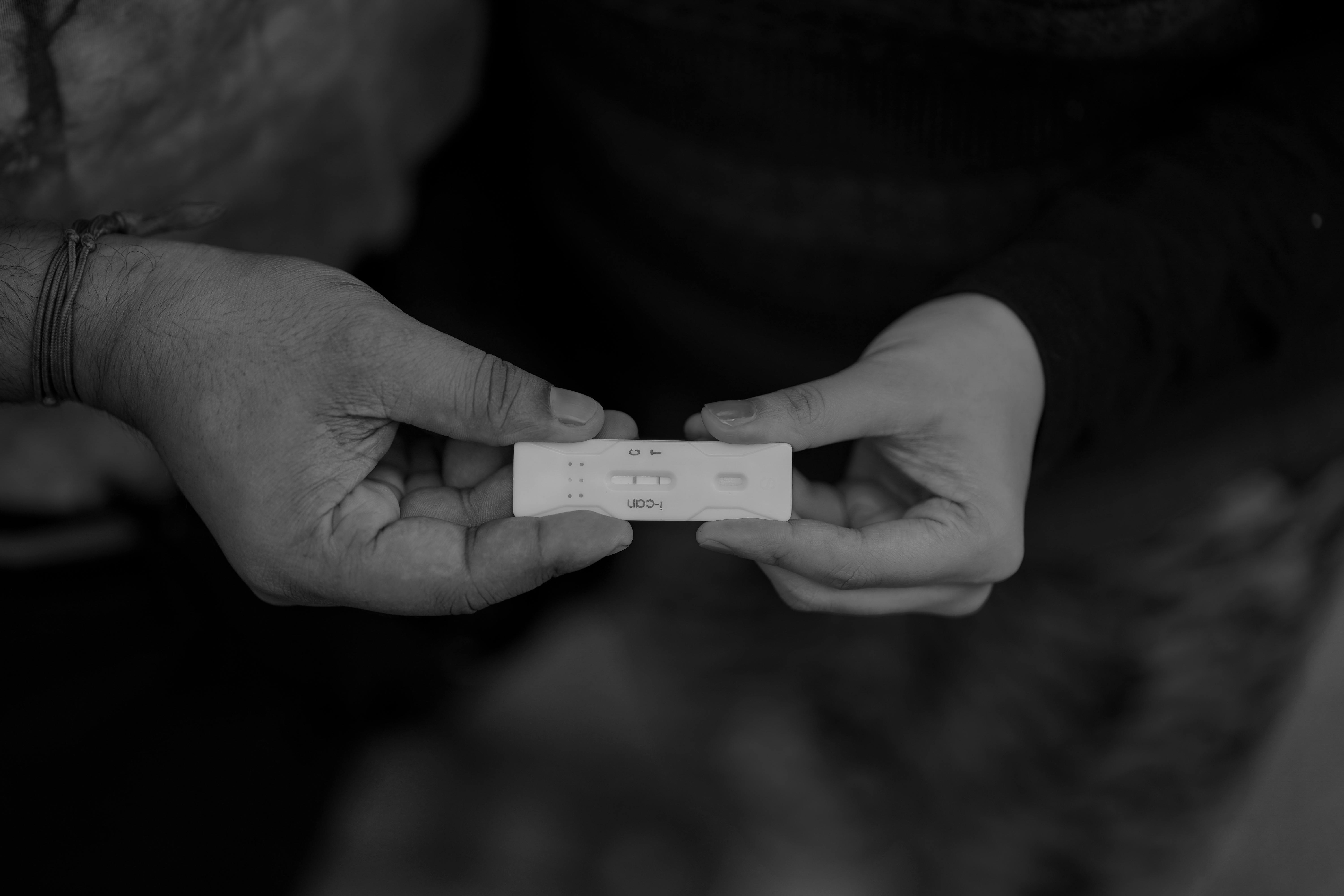 monochrome photo of a positive pregnancy test kit