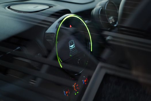Close-up of a futuristic car dashboard in selective focus, emphasizing modern design elements.