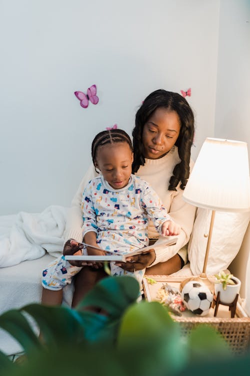 Mother Reading Book with Daughter