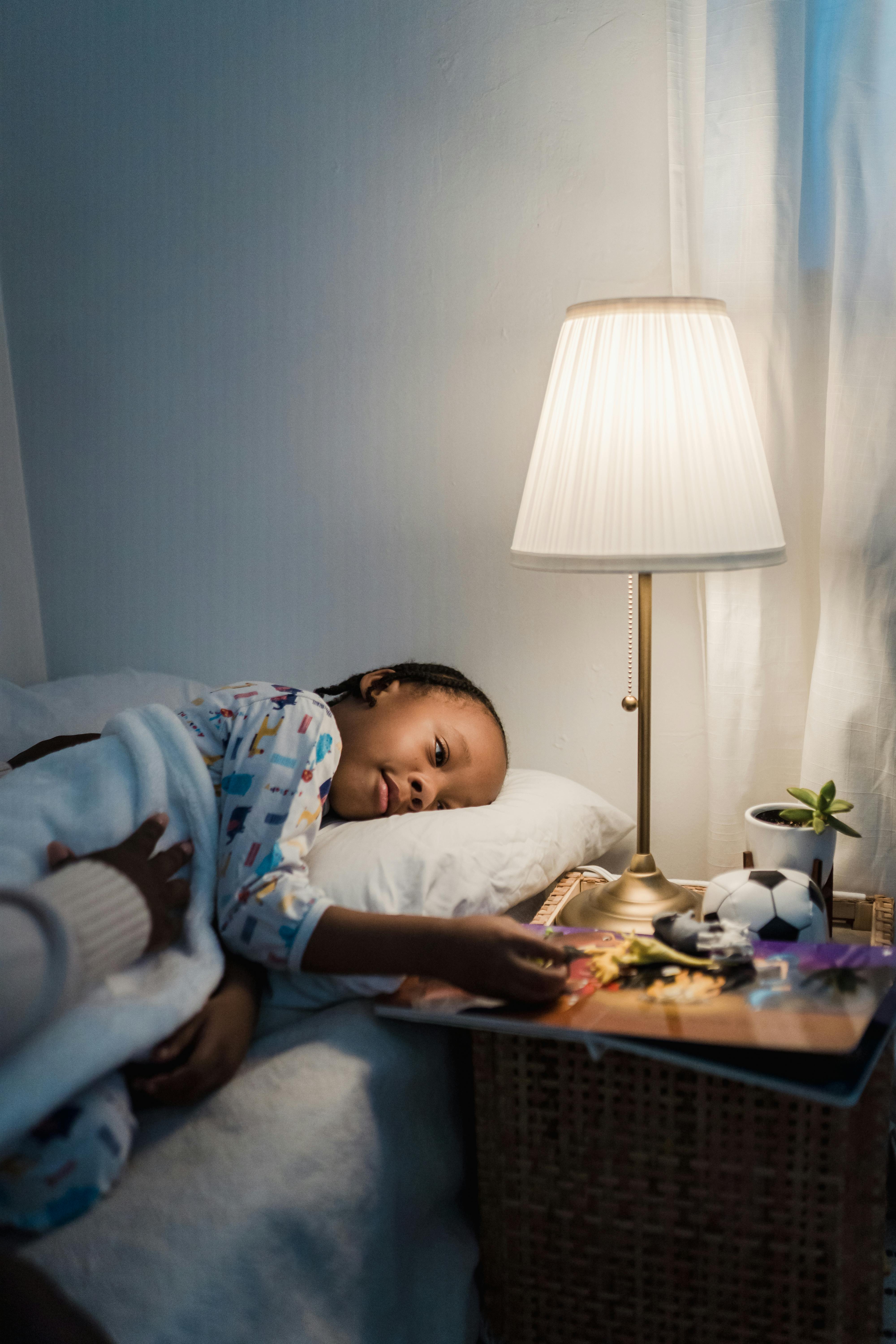 girl in bed looking at toys