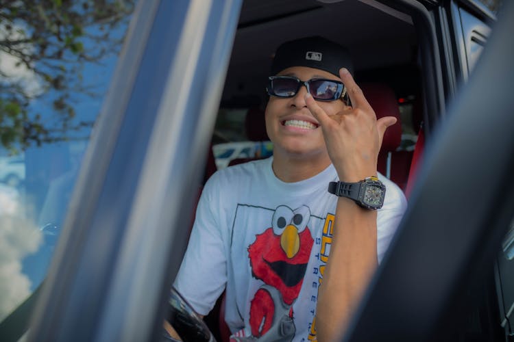 Happy Young Man Sitting In A Car 